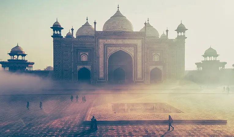 Tourist walk past ornate temples and architecture in Agra