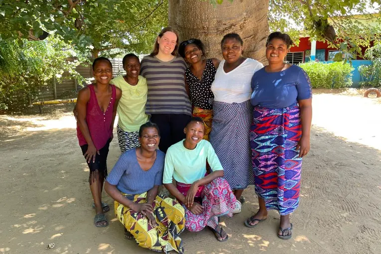 roots intern with locals under a tree