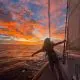 person in boat looking at the sunset