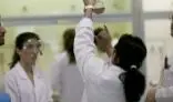 Group of Students holding a flask at a lab