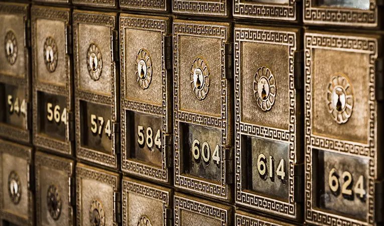 row of numbered vintage lockboxes at a bank