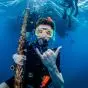 Scuba diver making hang loose sign.